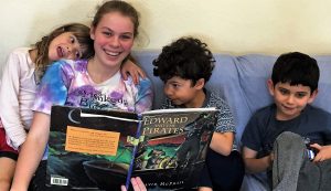 Counselor Audrey reads a book to kids at February Camp in Berkeley