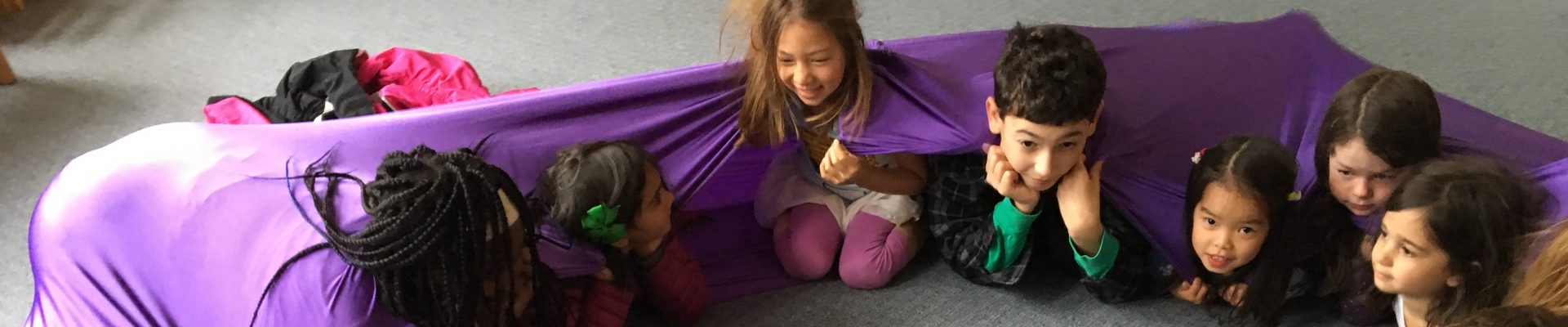 Campers looped up in a stretchy purple band at February Camp in Berkeley