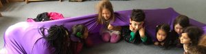 Campers looped up in a stretchy purple band at February Camp in Berkeley