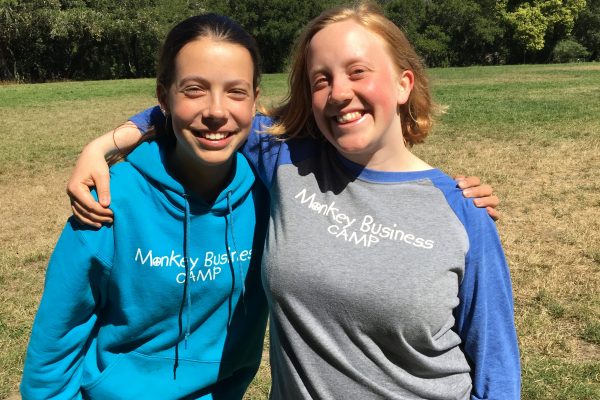 Camp Counselor Olivia and Site Director Ceri smiling in beautiful Tilden Park in Berkeley